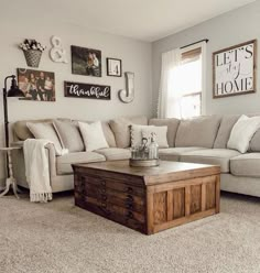 a living room filled with furniture and pictures hanging on the wall above a coffee table