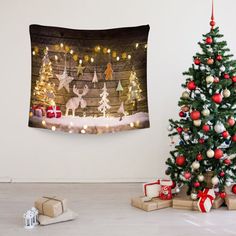 a christmas tree and presents in front of a wall hanging