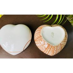 two heart shaped bowls sitting next to each other