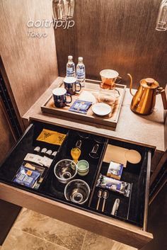 an open drawer in a bathroom filled with items