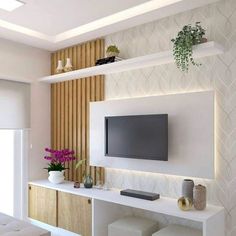 a living room with white furniture and a flat screen tv mounted to the side of a wall