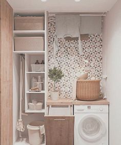 a washer and dryer in a small room next to a shelf with towels