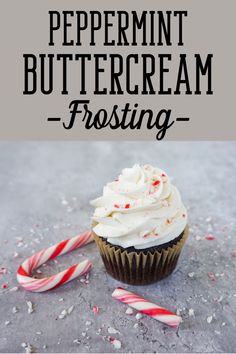 peppermint buttercream frosting on top of a cupcake with candy canes