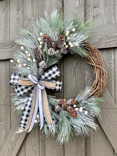 a christmas wreath with pine cones and berries