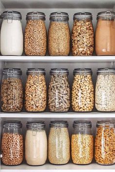 an organized pantry filled with lots of different types of cereals and grains in glass jars