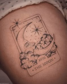 a tattoo on the side of a woman's thigh that reads, xiu the moon