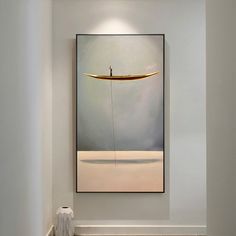 a painting hanging on the wall above a urinal in a white room with tile flooring