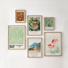 six framed pictures hang on the wall in front of a white wall with flowers and plants