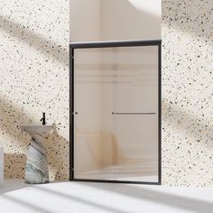 a bathroom with a sink, mirror and shower stall in the wall next to it