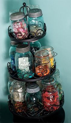 there is a three tiered glass jar display on the shelf with coins in it