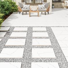 an outdoor living area with chairs and tables