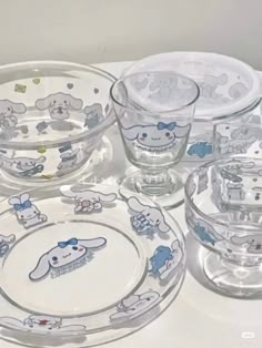 an assortment of glass dishes with cartoon characters on them