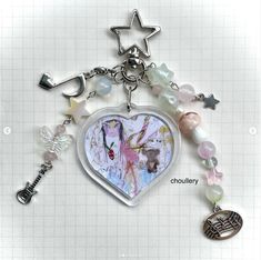 a heart shaped keychain with charms attached to it