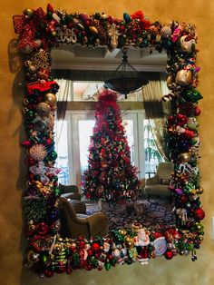 a decorated christmas tree sitting in front of a window