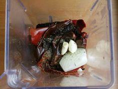 a plastic container filled with food on top of a wooden table