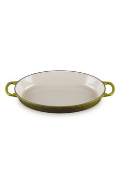 a green and white oval dish on a white background