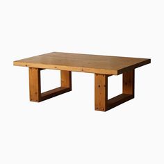 a wooden table sitting on top of a white floor