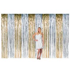 a woman standing in front of a backdrop with gold and silver foil fringes on it