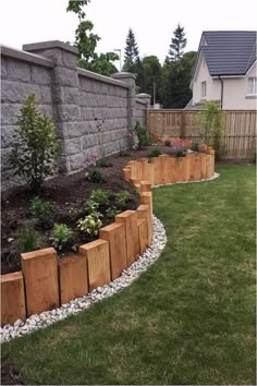 a garden with grass, rocks and plants in it