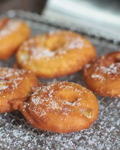 some sugared donuts are on a cooling rack