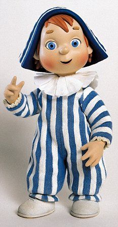 a toy doll dressed in blue and white striped clothes with a hat on his head