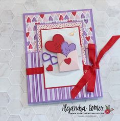 a close up of a card with hearts on it and a ribbon around the edge