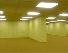 an empty room with lights on the ceiling and no one in it or someone else