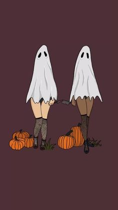 two people dressed in halloween costumes with pumpkins