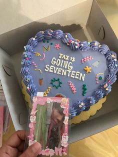 a cake in the shape of a heart with an image of a woman on it