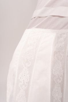 Stunning Edwardian 1910’s white cotton and lace maxi petticoat skirt. With a pretty flare silhouette, panel lace detail, and a button closure at waist. Good vintage condition, with normal wear and condition for its age. Some areas of visible mending a minor staining - see pictures. Best fits modern size XS/S Waist 26”Length 42” Featured top is the Blue Doll Quilt Corset from our friends at Psychic Outlaw. Model’s Measurements:Height 5’9”Chest 34”Waist 29”Hips 36.5” Elegant White Broderie Anglaise Bottoms, Elegant White Bottoms With Broderie Anglaise, White Lace Patchwork Long Skirt, Daywear Long Lace Skirt, Elegant Cotton Wedding Skirt, White Lace Vintage Bottoms, Vintage White Lace Bottoms, White Vintage Lace Bottoms, Fitted White Lace Skirt