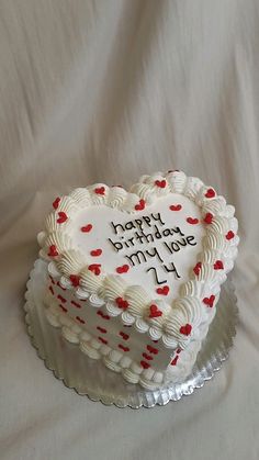 a heart shaped birthday cake with writing on it