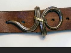 a leather belt with two metal rings on it