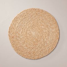 a round woven placemat on a white surface