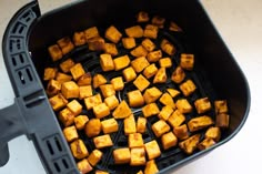 cubes of food being cooked in an air fryer