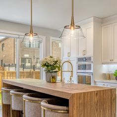 a kitchen island with stools in front of it