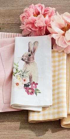 pink flowers and napkins on a wooden table