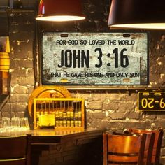 a sign that reads john 3 16 on the side of a brick wall in a restaurant