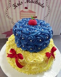 a blue and yellow cake sitting on top of a white plate next to a box