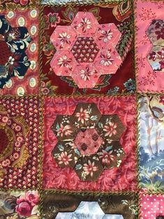 a patchwork quilt with many different designs on it