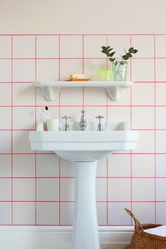 a white sink sitting under a bathroom mirror next to a shelf filled with soap and toothbrushes