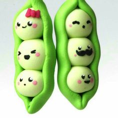 two peas with faces painted on them are in the shape of a couple of peas