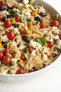 a white bowl filled with pasta and vegetables