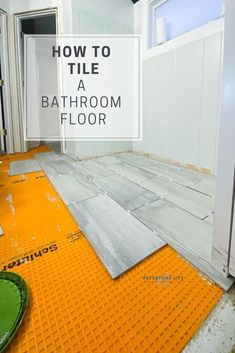 a room with yellow flooring and white walls that says how to tile a bathroom floor