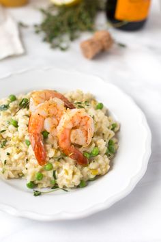 a white plate topped with rice and shrimp