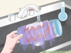 a person is washing their hands under a faucet with soap and water on it