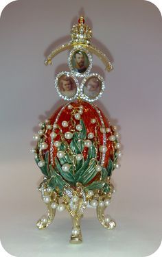 a glass figurine that has been decorated with pearls and other things on it