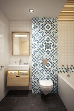 a white toilet sitting next to a bath tub in a bathroom under a mirror above a sink