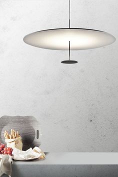 a table with some food on it and a light hanging over the top of it