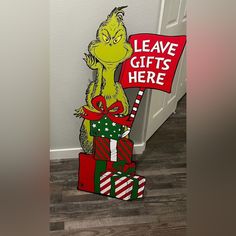 the cat in the hat is holding a sign that says leave gifts here