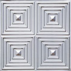 four square white tiles with silver squares on them